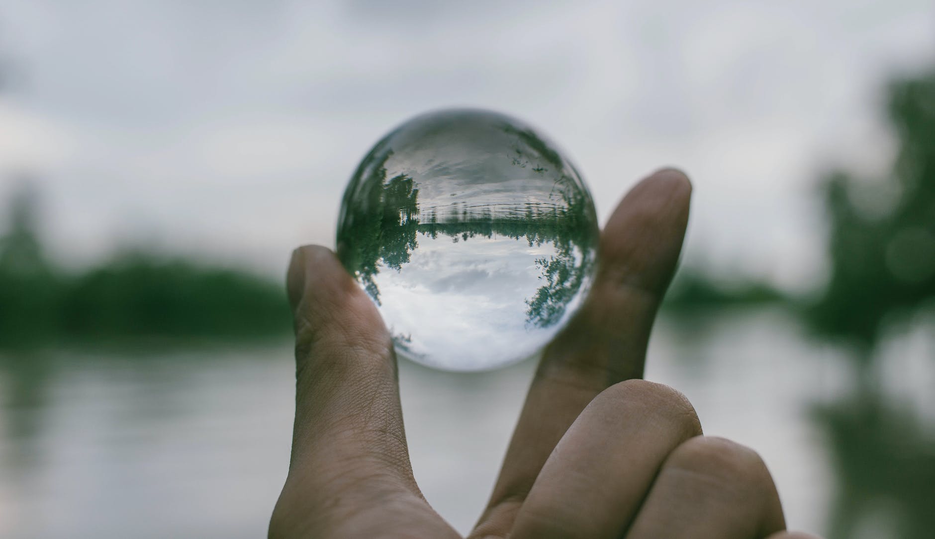 close up photography of person holding crystal ball